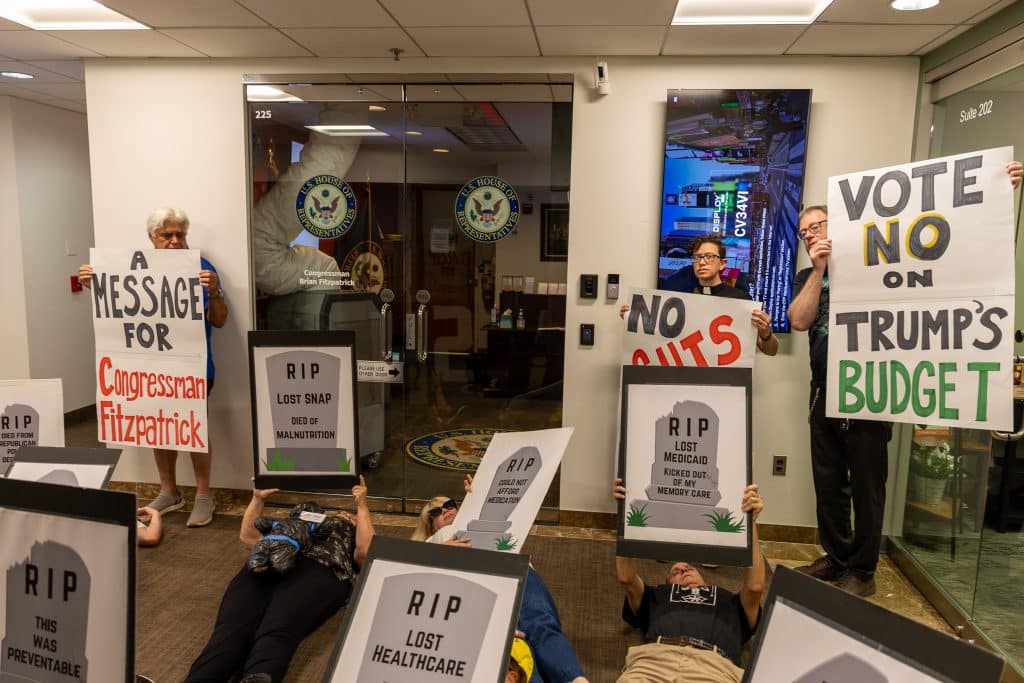 Indivisible DIE IN 1 1 - Bucks County Beacon - PHOTO ESSAY: Hundreds Participate in Die-in at Congressman Brian Fitzpatrick’s Office to Highlight Deadly Stakes of GOP Budget