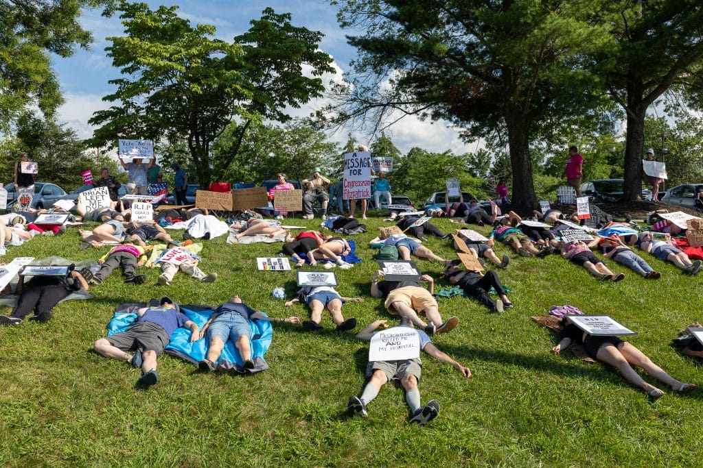 Indivisible DIE IN 12 - Bucks County Beacon - PHOTO ESSAY: Hundreds Participate in Die-in at Congressman Brian Fitzpatrick’s Office to Highlight Deadly Stakes of GOP Budget